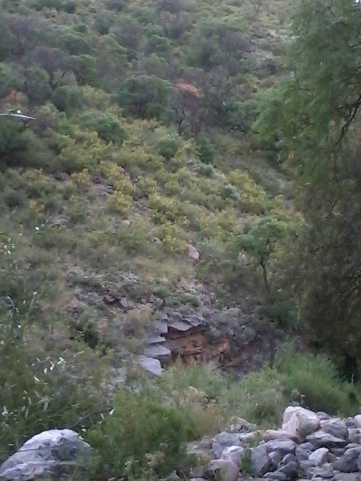 A rocky stream bed behind the hill